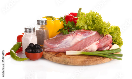 Raw meat and vegetables on a wooden board isolated on whitе photo