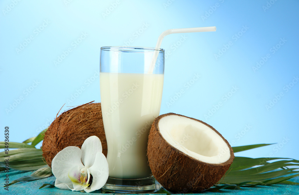 Coconuts with glass of milk, on blue background Coconuts with glass of milk, on blue background