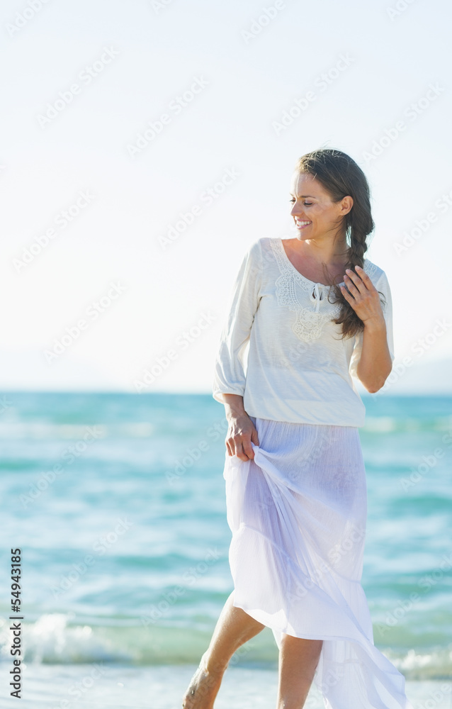 Portrait of happy young woman on sea coast