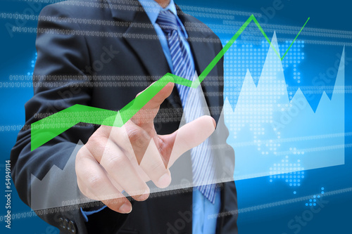 businessman hand pushing a business graph on a touch screen inte