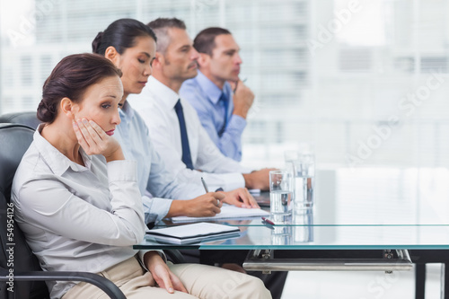 Businesswoman getting bored while attending presentation