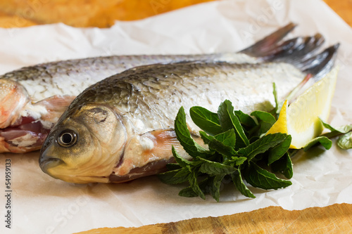 Fresh raw fish on wooden table photo