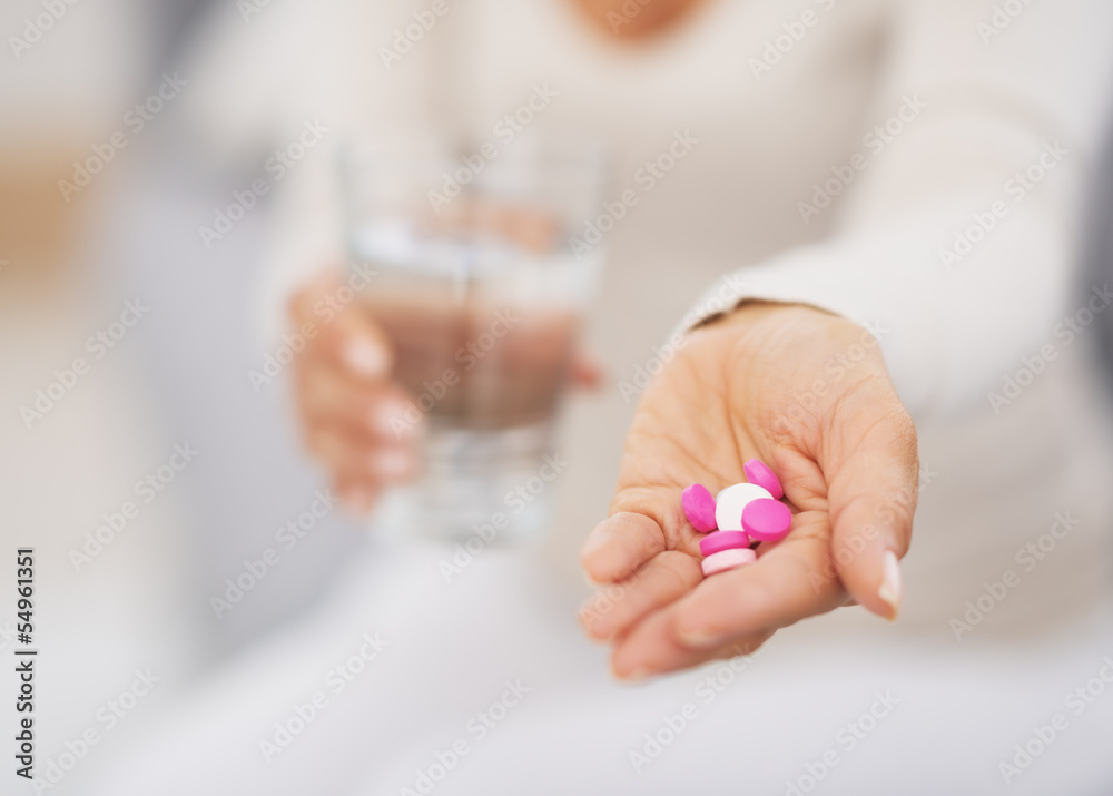 Closeup on pills in hand of young woman Closeup on pills in hand of young woman