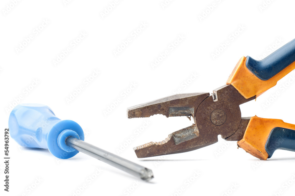 Screwdriver and rusty pliers on white Screwdriver and rusty pliers on white