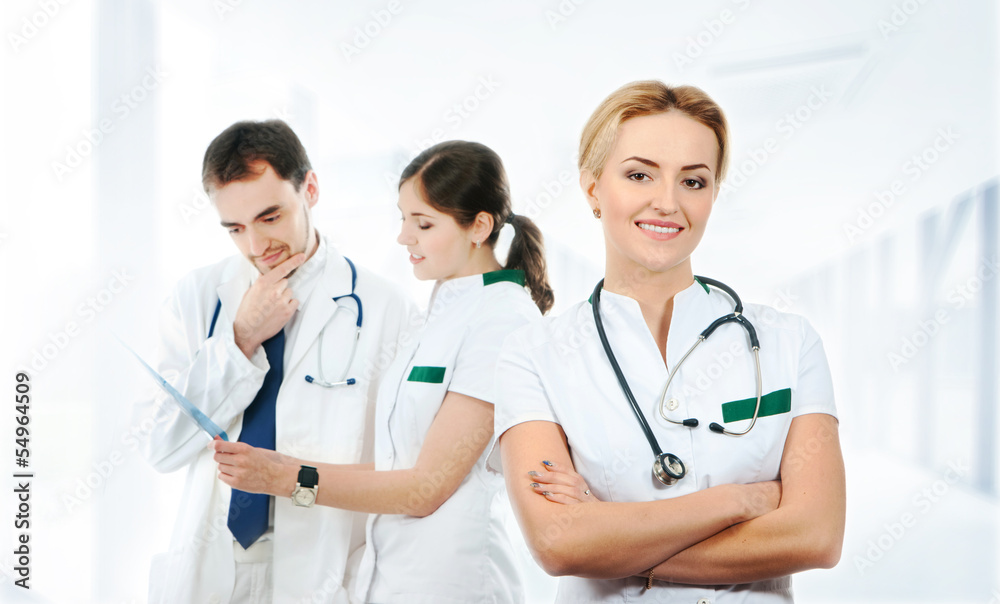 A team of young Caucasian medical workers in white clothes A team of young Caucasian medical workers in white clothes
