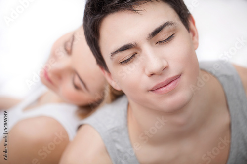 Loving couple relaxing together. Top view of young loving couple