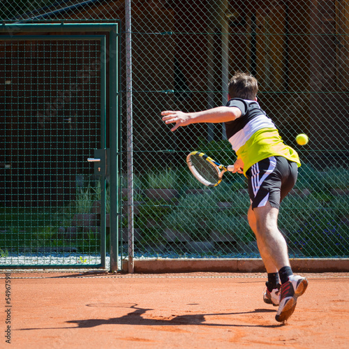 defense action of tennis player on sand court