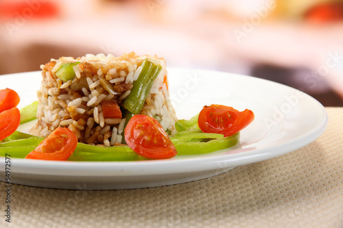 Delicious risotto with vegetables on table in cafe