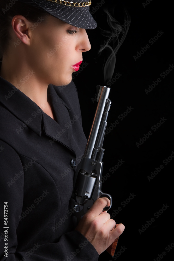 Dangerous woman in black with silver smoking handgun Dangerous woman in black with silver smoking handgun