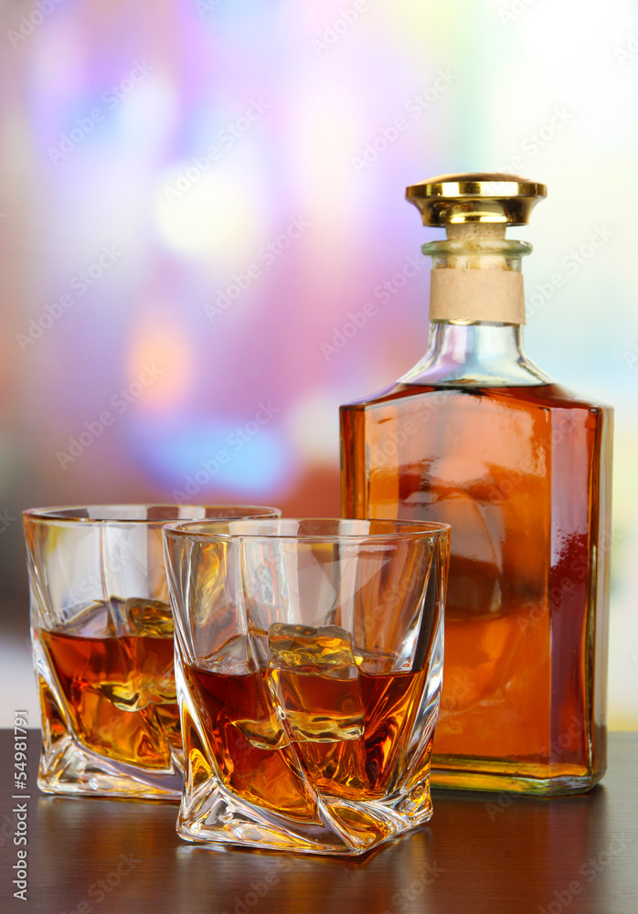 Glass of whiskey with bottle, on dark background Glass of whiskey with bottle, on dark background