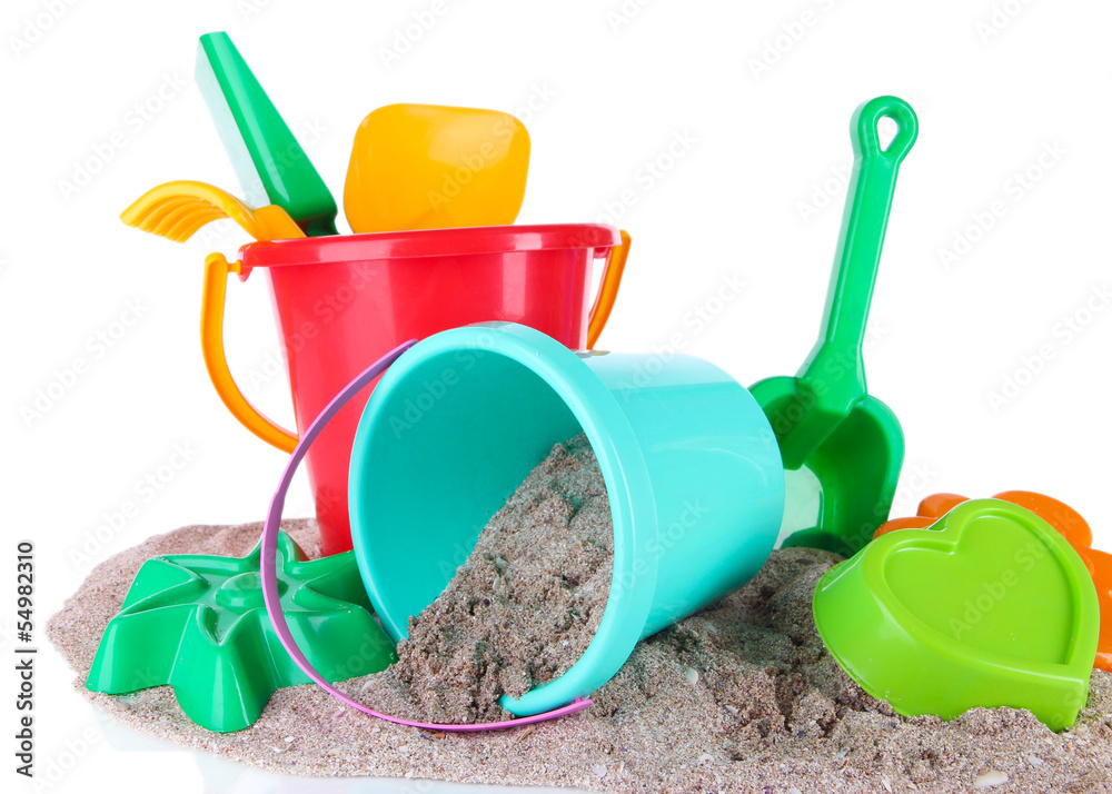 Children's toys on sand isolated on white Children's toys on sand isolated on white