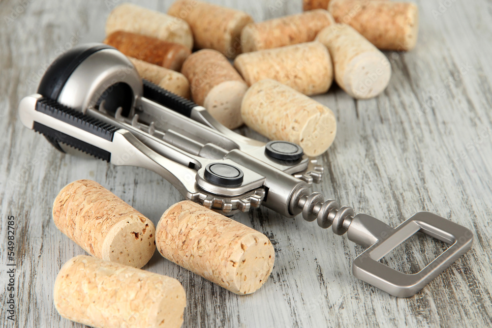 Corkscrew with wine corks and bottle of wine