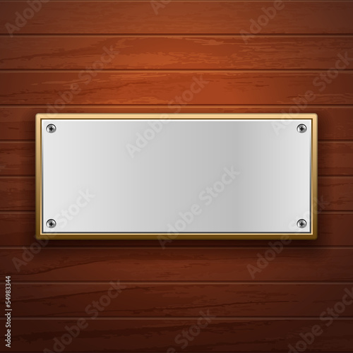 Metal plate on wooden surface