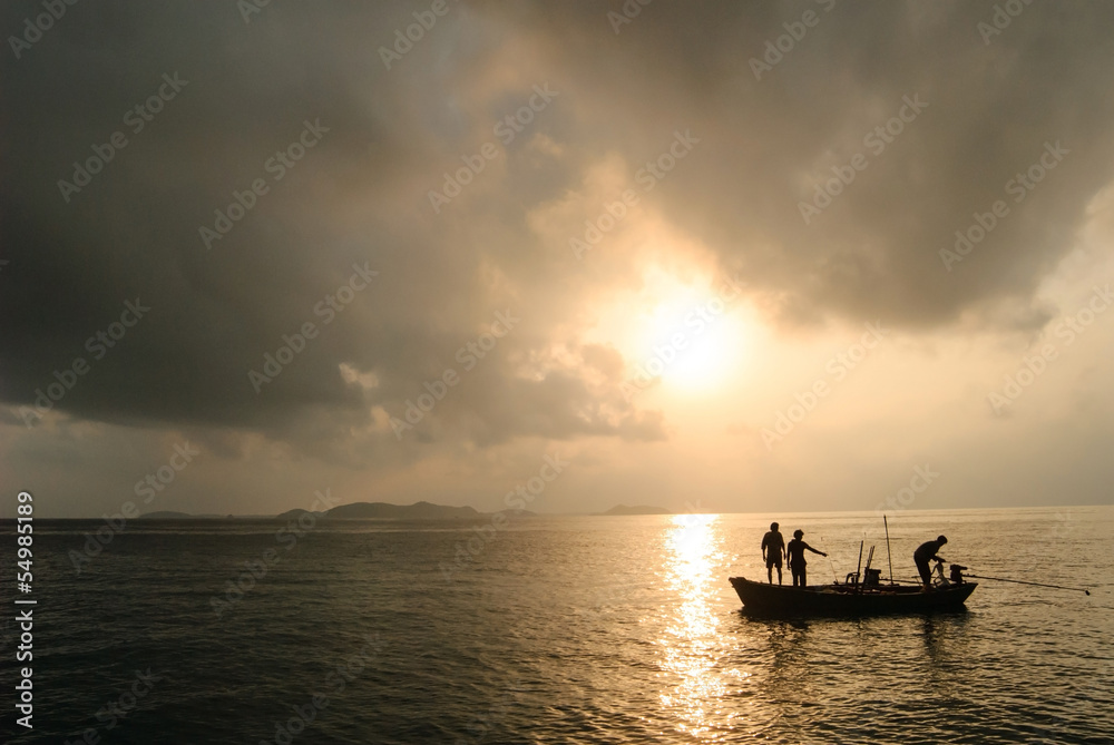 silhouette of fishermen with they boat