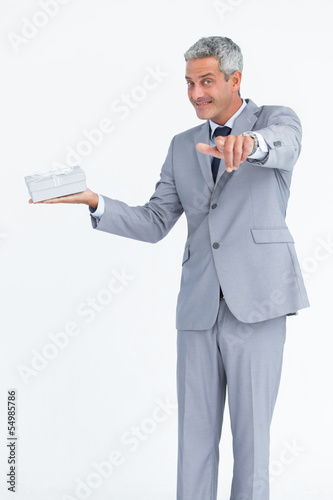 Confident businessman pointing at camera