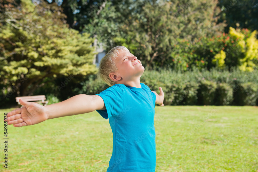Boy stretching his arms and enjoying the sun Boy stretching his arms and enjoying the sun
