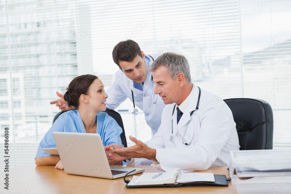 Doctors and surgeon discussing together Doctors and surgeon discussing together