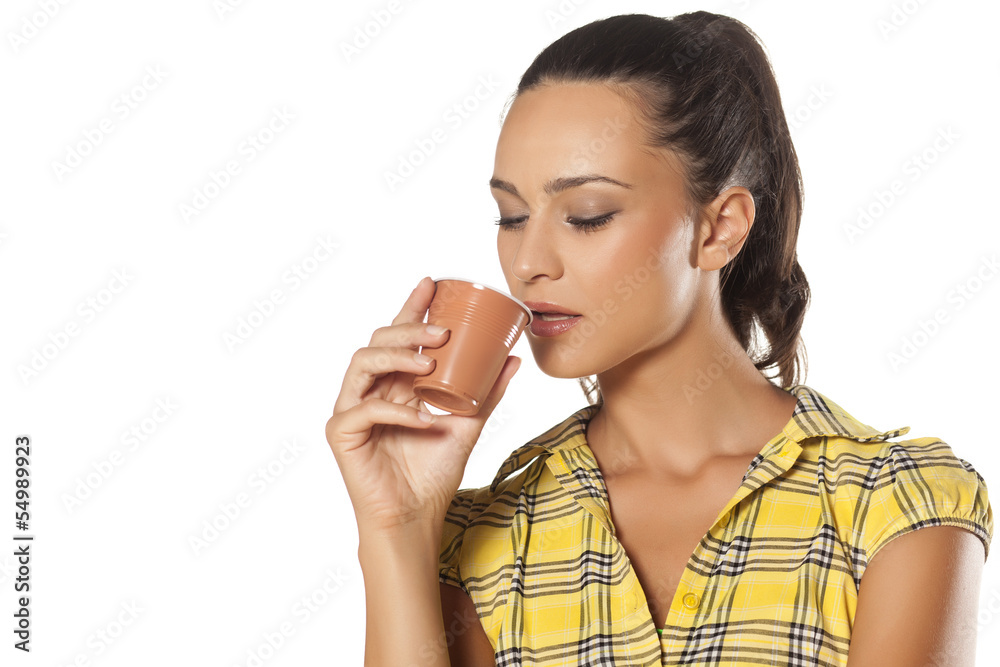 young brunette enjoys the smell of her coffee from the machine young brunette enjoys the smell of her coffee from the machine