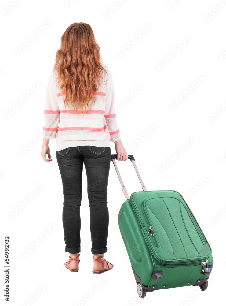 back view of walking woman with suitcase. back view of walking woman with suitcase.