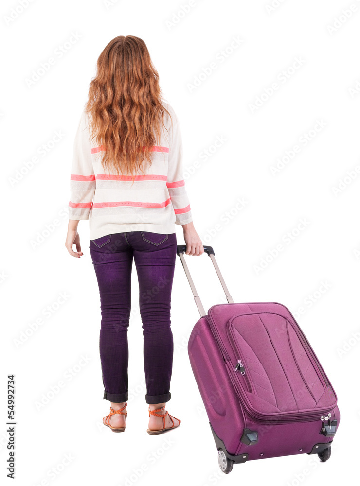 back view of walking woman with suitcase. back view of walking woman with suitcase.