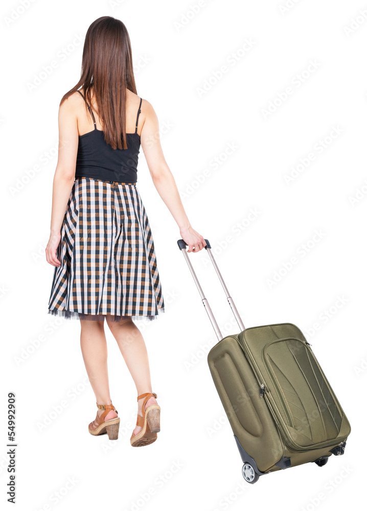 back view of walking woman with green suitcase. back view of walking woman with green suitcase.