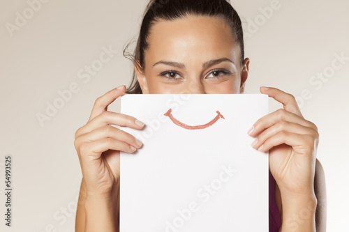 happy and smiling girl with a smile painted on paper photo