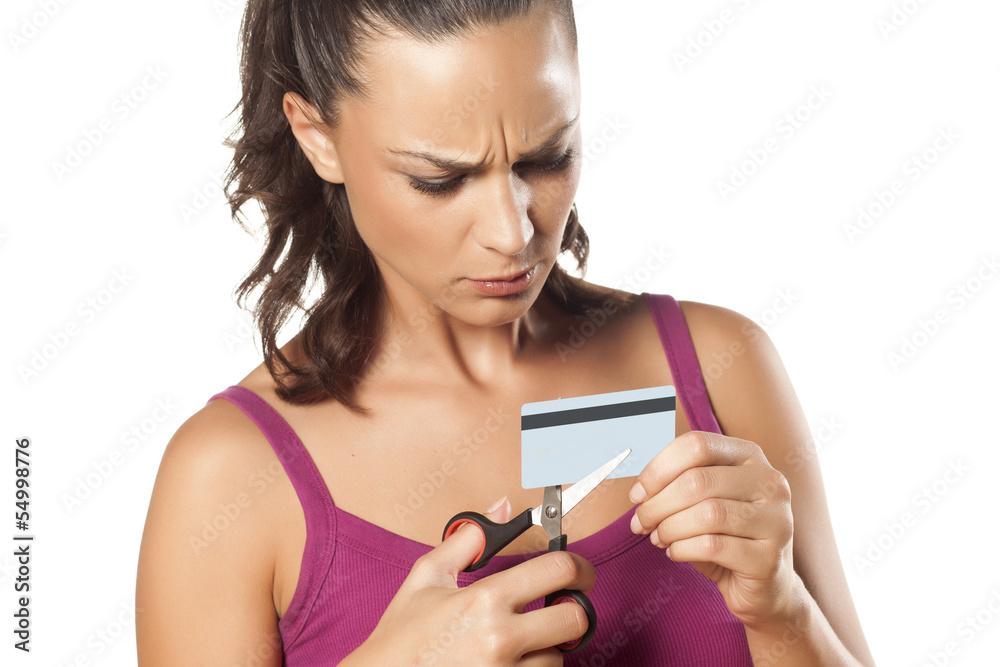 angry beautiful girl destroying her credit card with scissors angry beautiful girl destroying her credit card with scissors