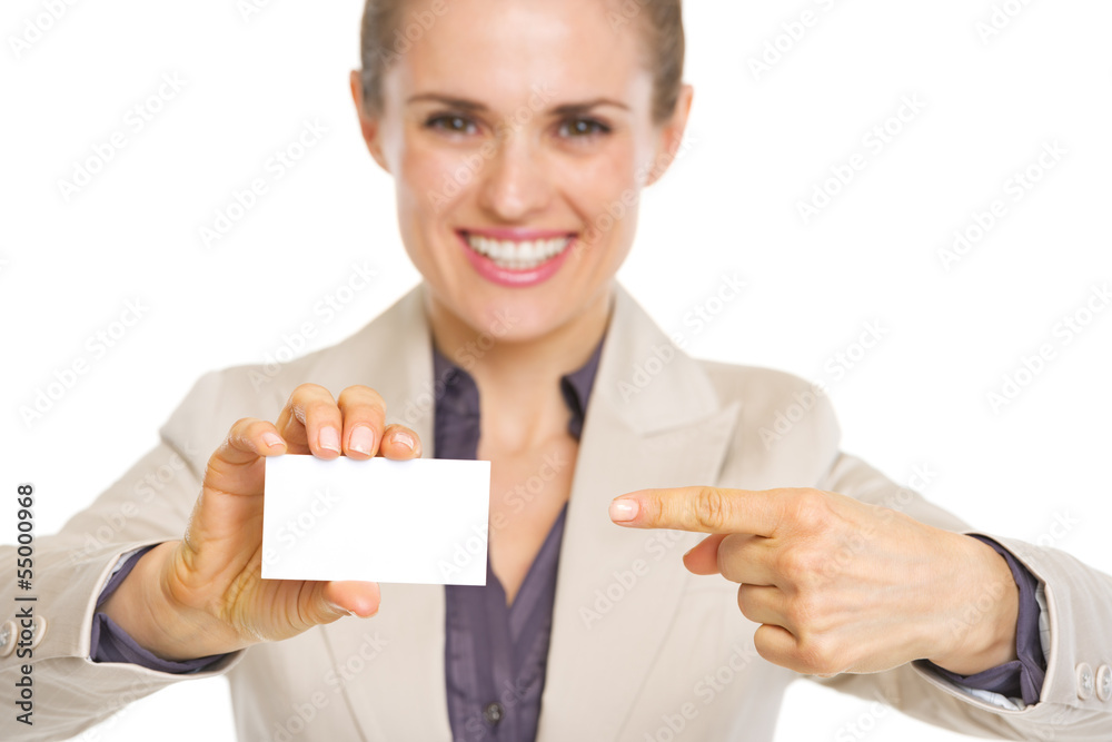 Closeup on smiling business woman pointing on business card