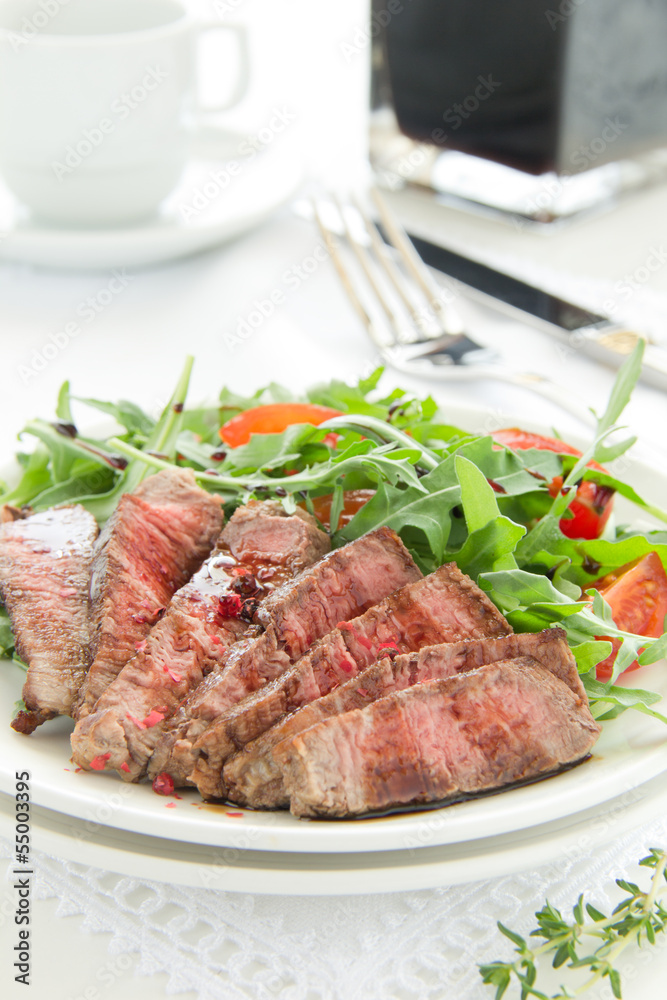 roast beef with salad of arugula and tomatoes.