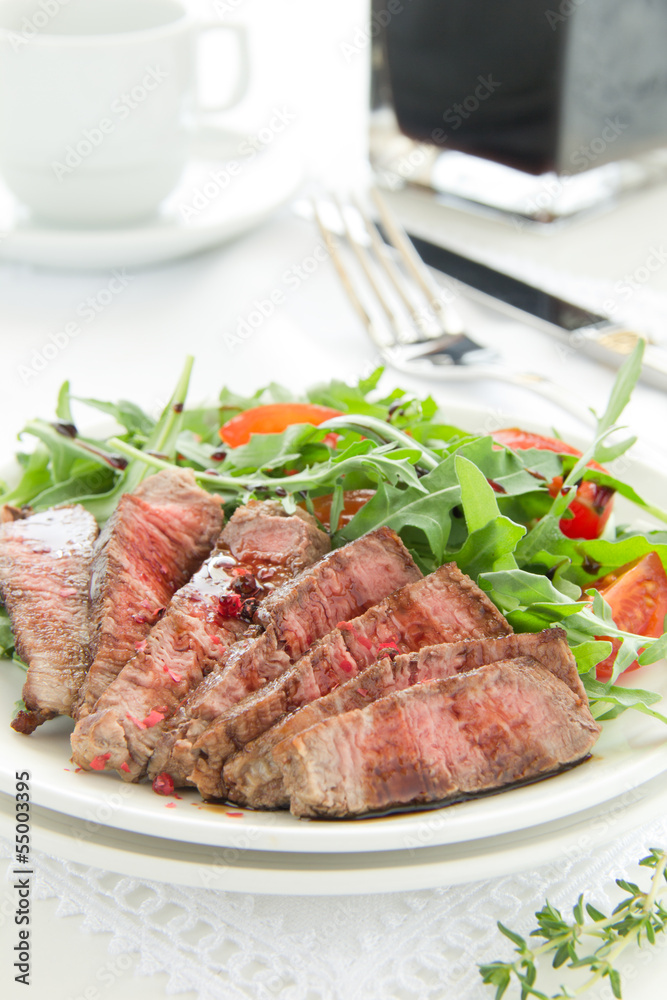 roast beef with salad of arugula and tomatoes. roast beef with salad of arugula and tomatoes.
