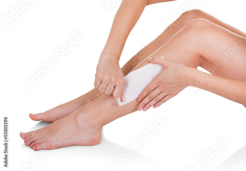 Close-up Of Woman Waxing Legs