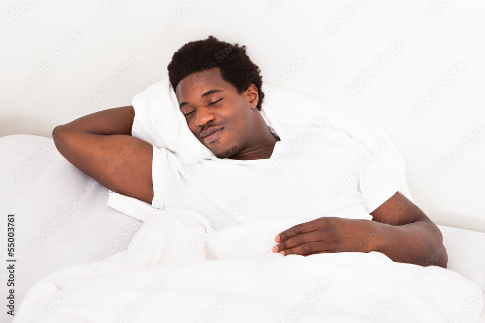 Young African Man Sleeping In Bed Young African Man Sleeping In Bed
