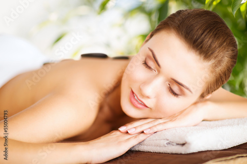 woman in spa with hot stones