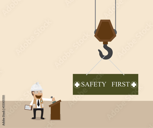 Businessman control crane hanging with safety first sign