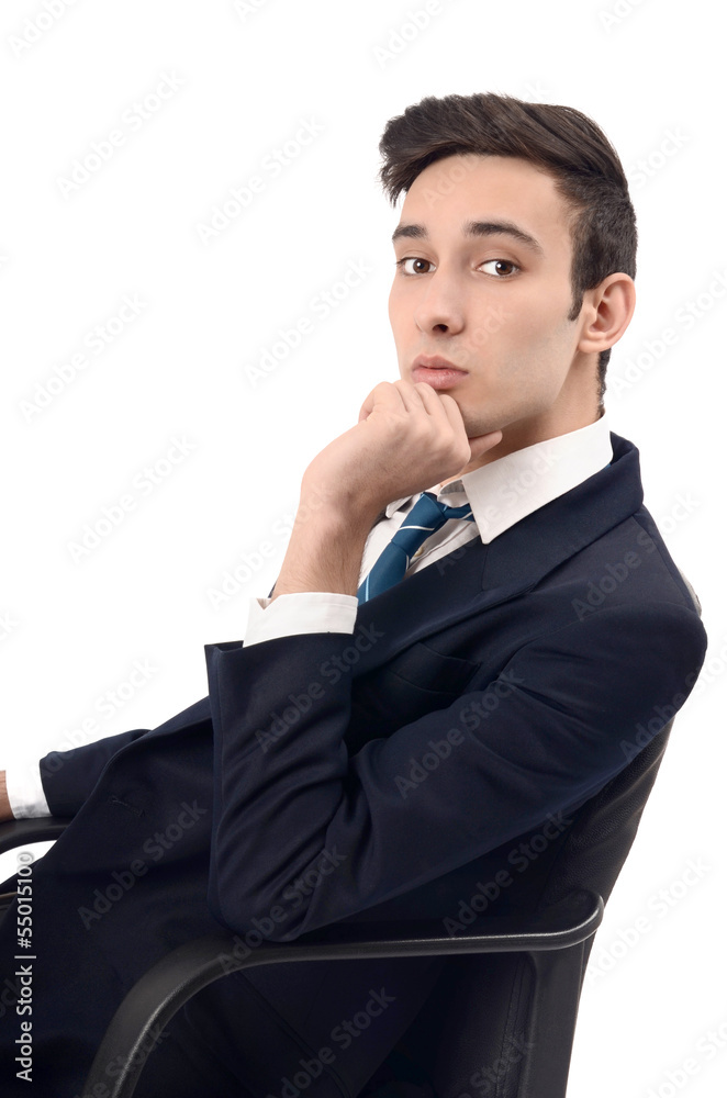 Young business man sitting on the chair, wearing a suit Young business man sitting on the chair, wearing a suit