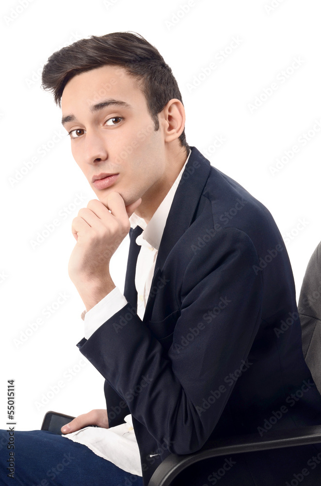 Young business man sitting on the chair, wearing a suit Young business man sitting on the chair, wearing a suit