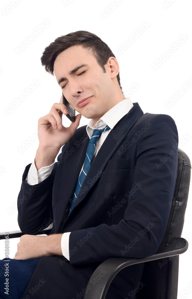 Young businessman crying on the phone.Upsetting phone news Young businessman crying on the phone.Upsetting phone news