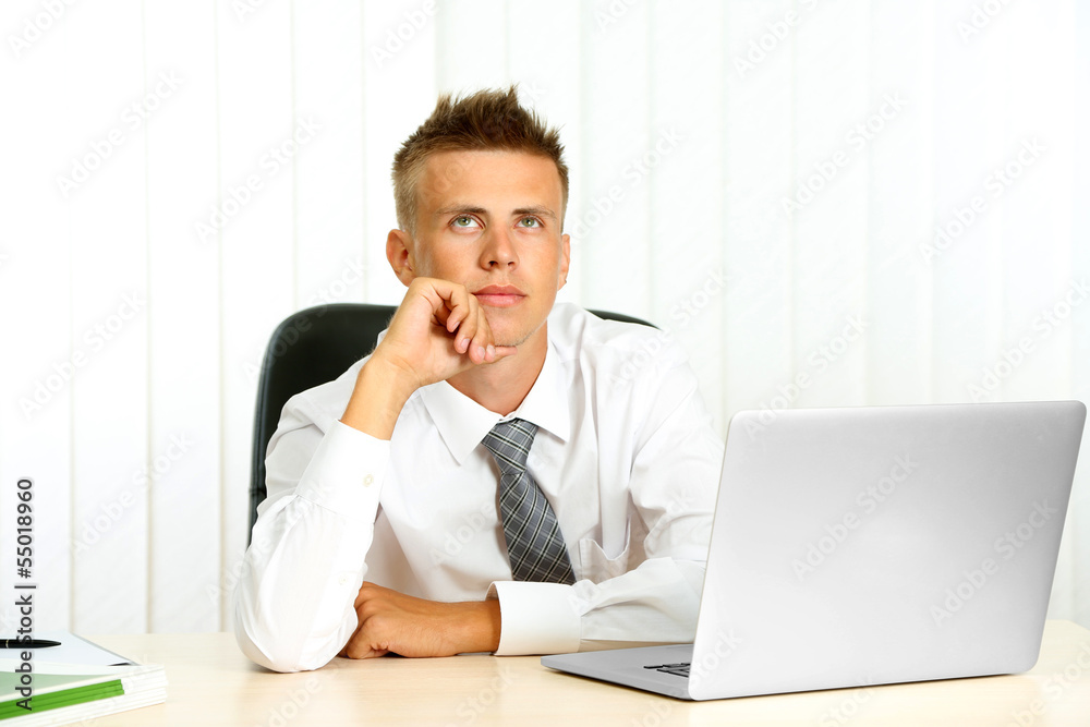 Portrait of young businessman in office Portrait of young businessman in office