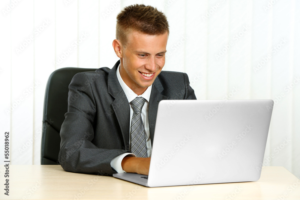 Portrait of young businessman working in office Portrait of young businessman working in office