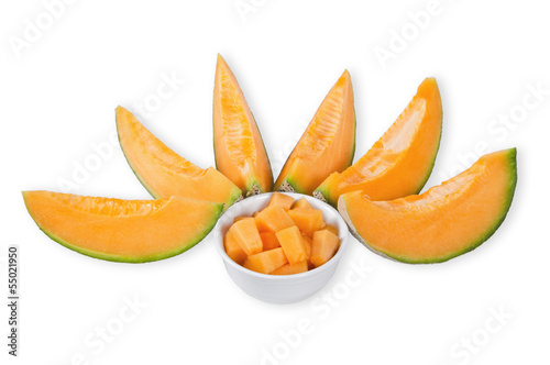 Cantaloupe melon slices and cubes over white