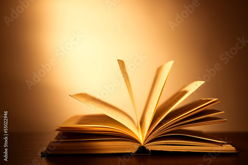 Hardcover book lying open on its cover with the pages 