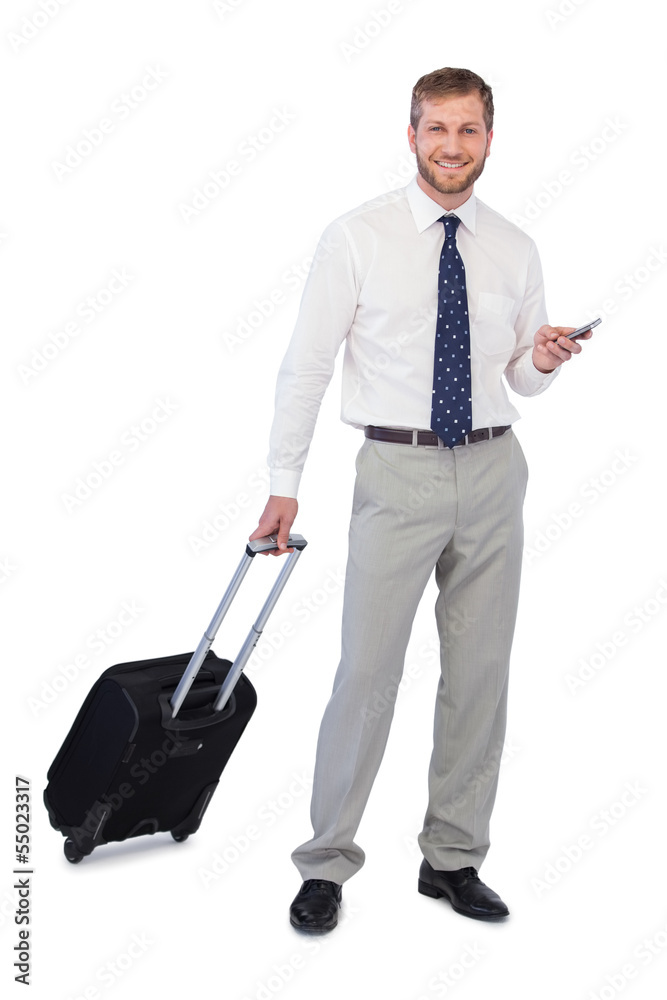 Businessman with phone and suitcase looking at camera Businessman with phone and suitcase looking at camera