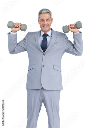 Businessman lifting dumbbells