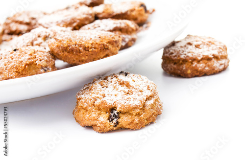 Pile of chocolate chip cookies on a dish on white background