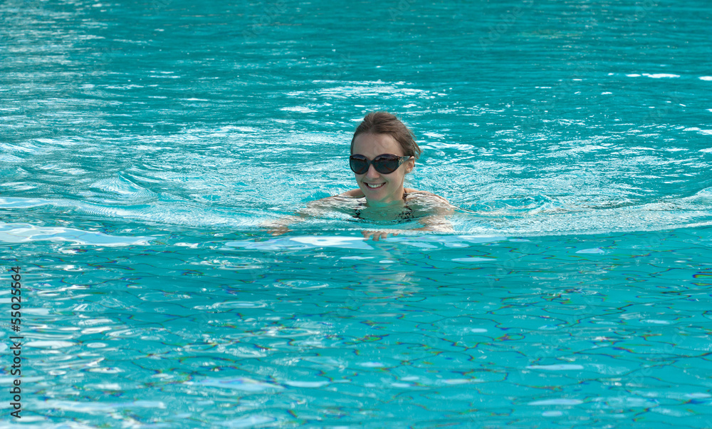 Happy young woman swimming