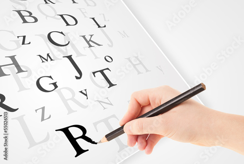 Hand writing various letters on white plain paper