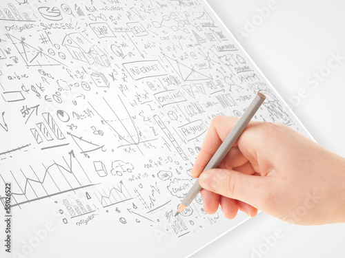 Human hand sketching ideas on a white paper