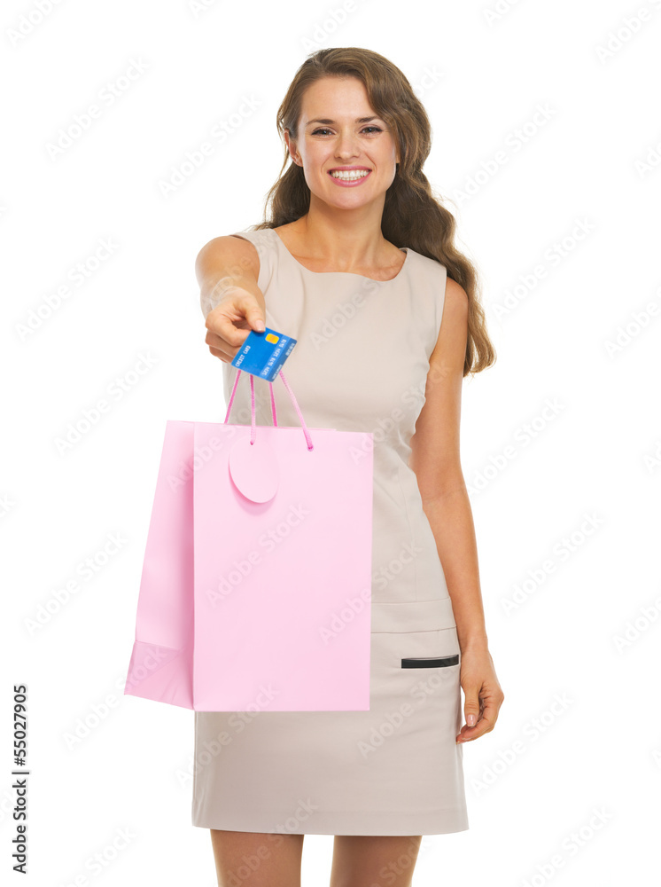 Smiling young woman showing shopping bag and credit card Smiling young woman showing shopping bag and credit card