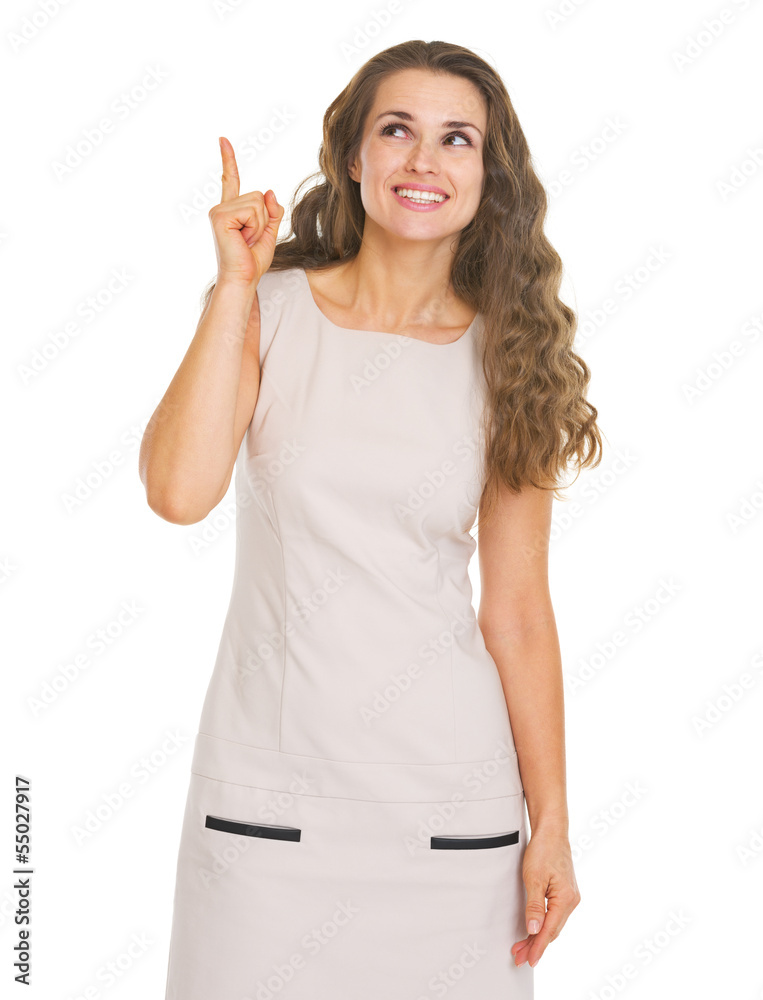 Happy young woman pointing up on copy space Happy young woman pointing up on copy space