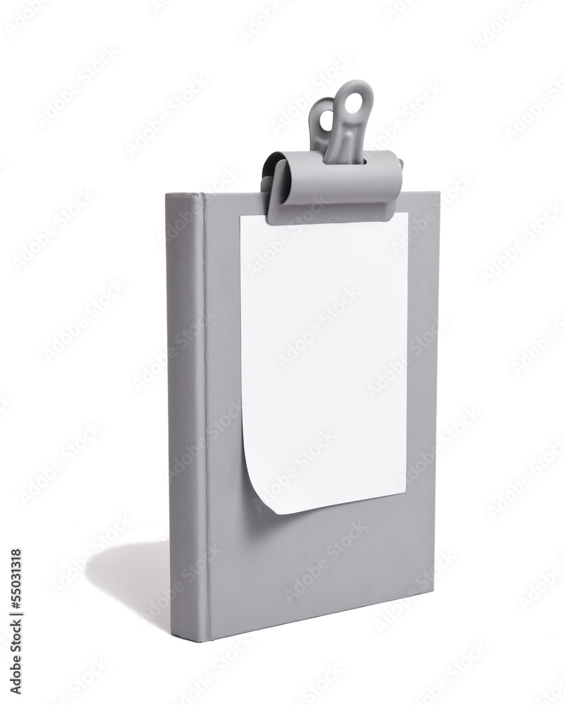 White Paper Clipped to Grey Book White Paper Clipped to Grey Book